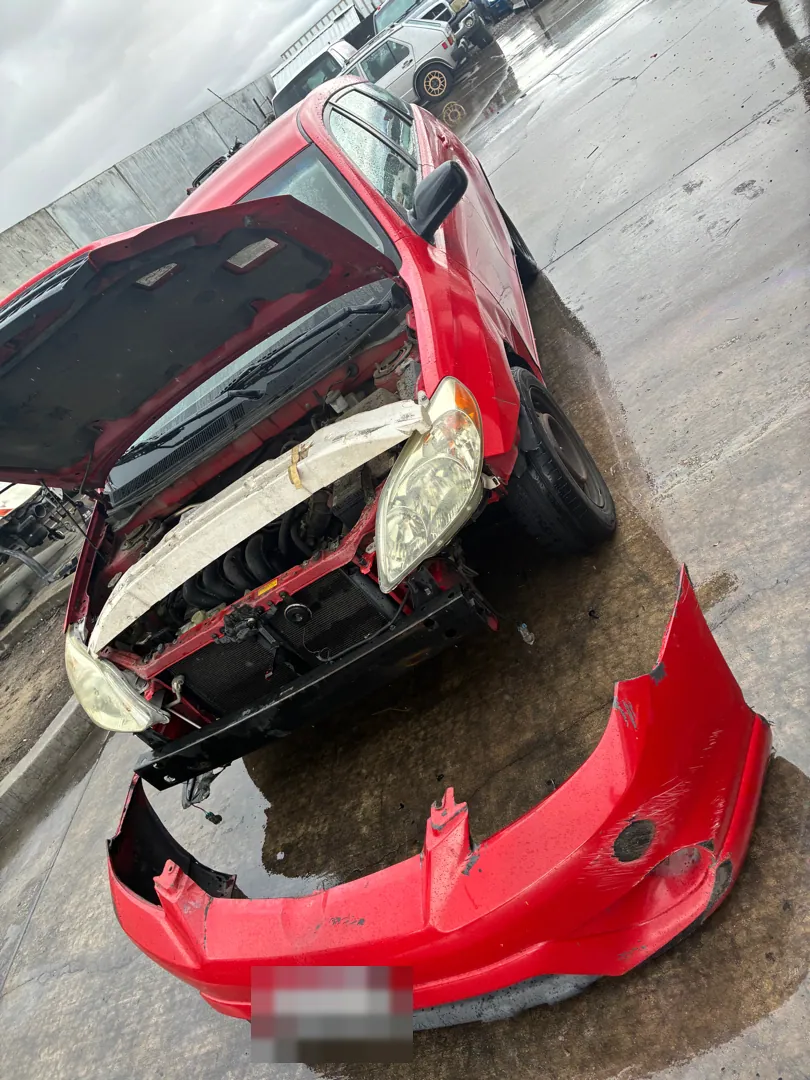 2005 Toyota Matrix with the front bumper cover off, ready to be refitted properly — Riverside, CA