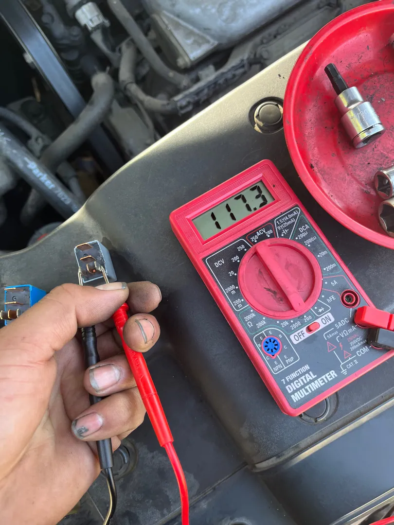 Ignition coil under test with a multimeter before anything gets replaced — Riverside, CA