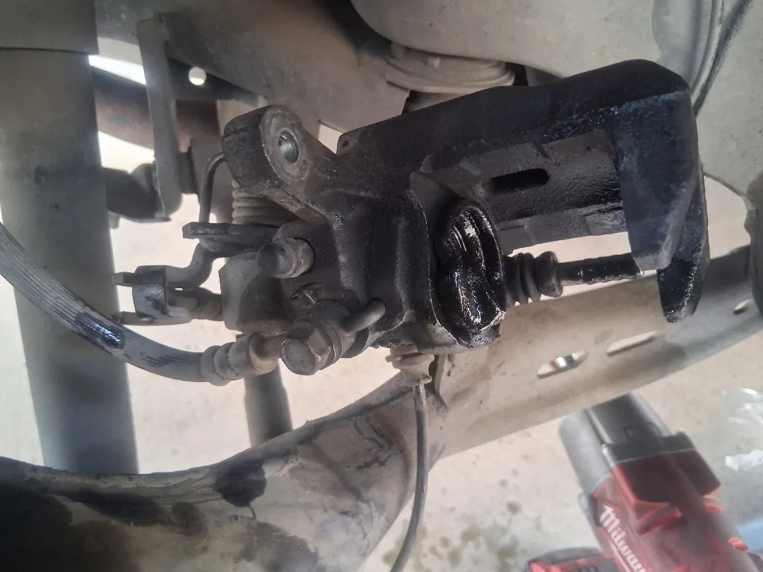 Underside of the rear caliper with the flex hose and bracket in view — Hemet, CA